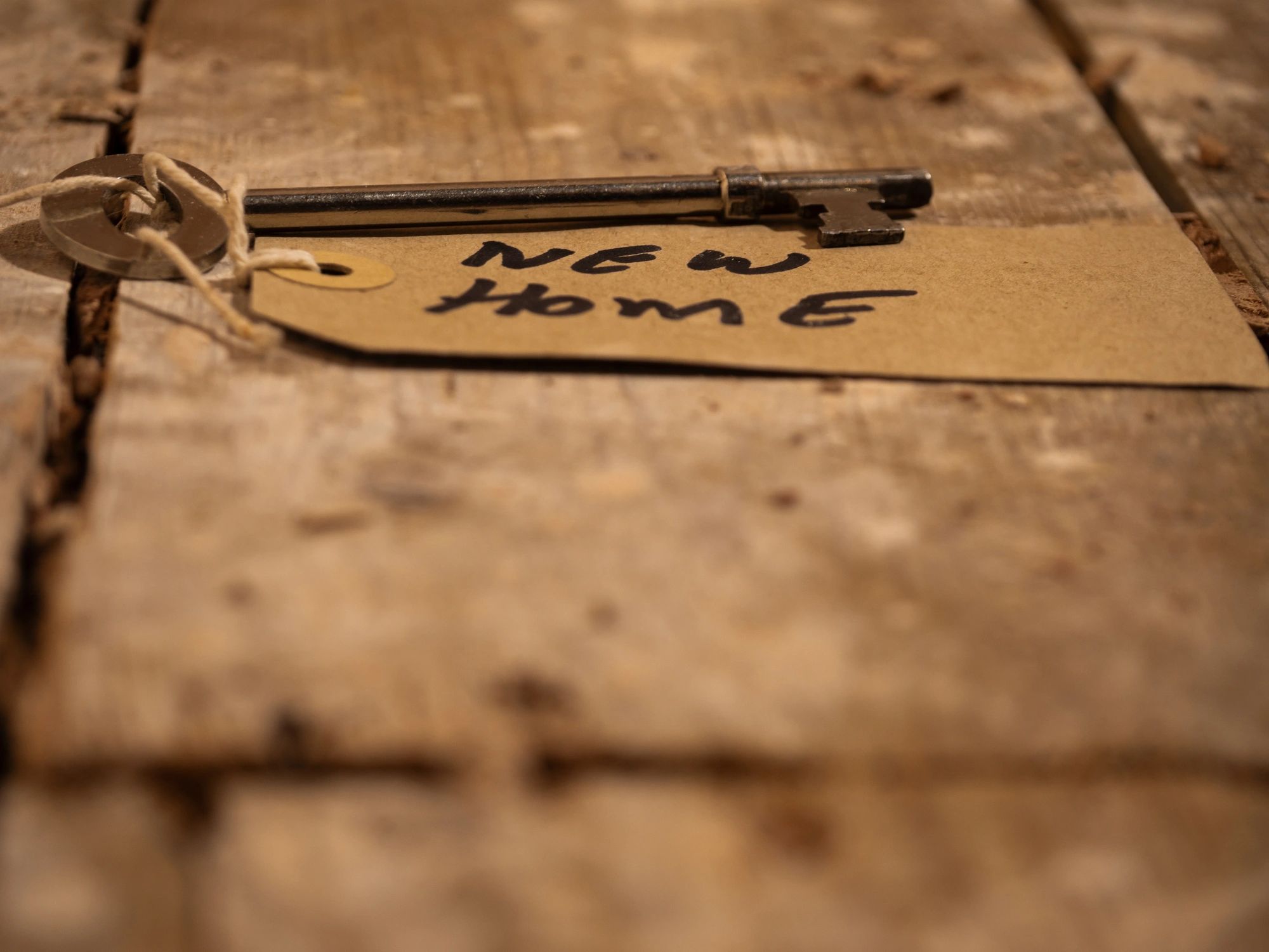 Key to a home beside property paperwork